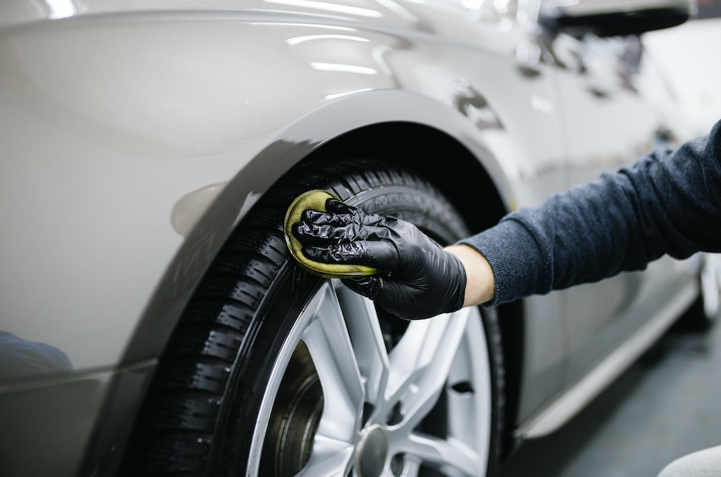 Cleaning the wheel on a car.