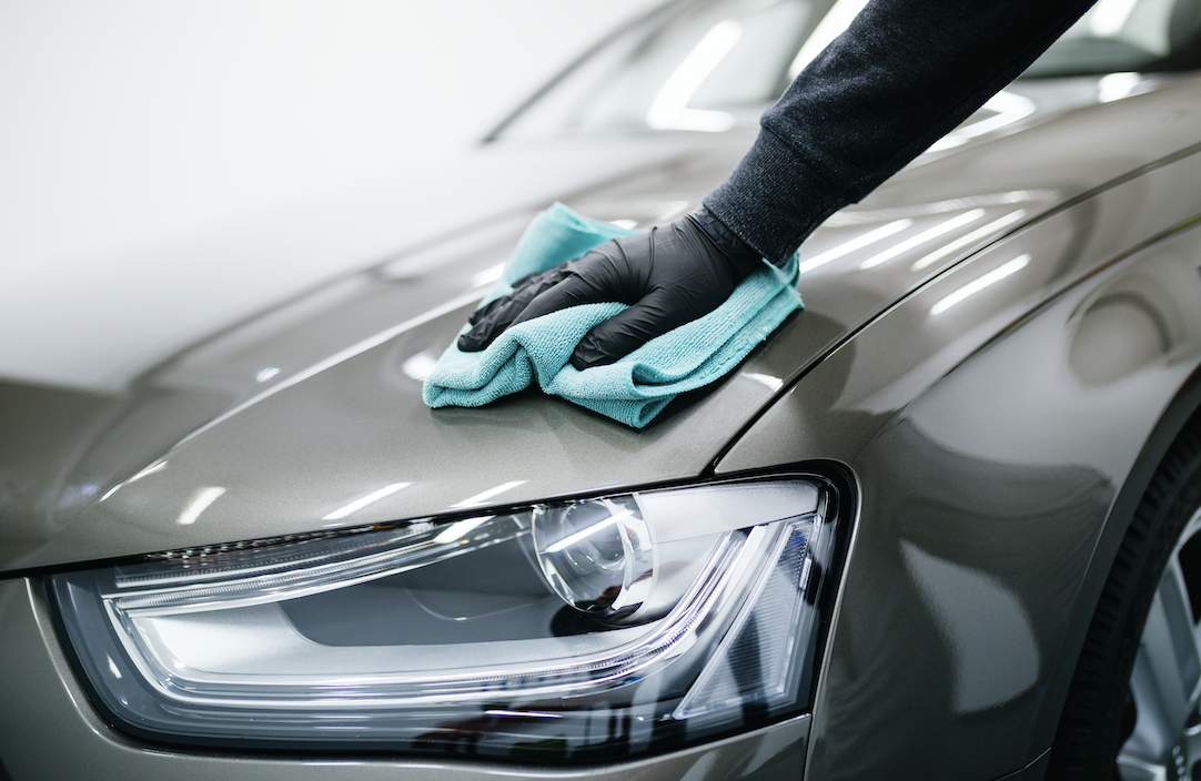 Polishing a grey cars surface.